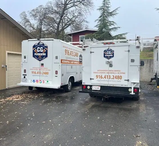 Fleet of CG Plumbing service trucks lined up in the yard in Sacramento County, CA, featuring company branding and professional plumbing equipment.